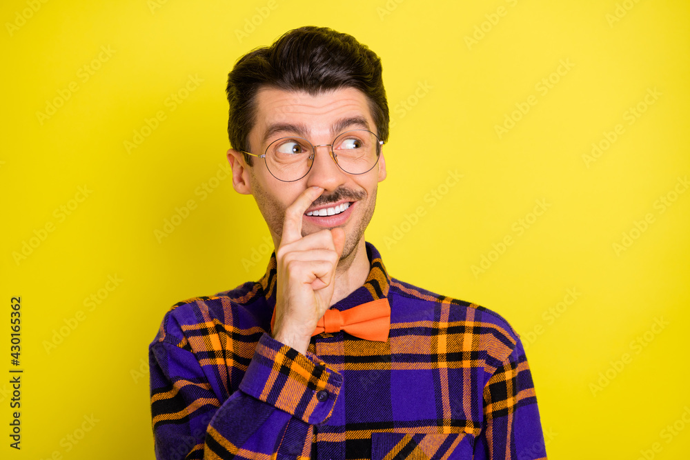 Sticker Photo of foolish guy finger nose look empty space wear bow tie checkered shirt isolated yellow color background