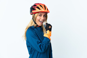 Young blonde Uruguayan cyclist woman isolated on background celebrating a victory