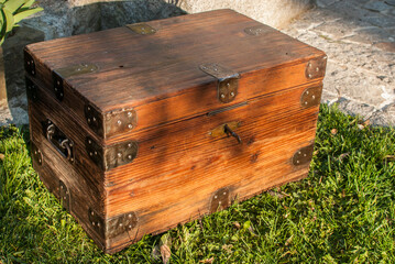 Old retro vintage wooden chest on house garden closeup