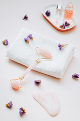 Gua sha beauty roller and rose facial serum, top view