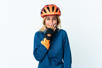 Young blonde Uruguayan cyclist woman isolated on background happy and smiling covering mouth with hand