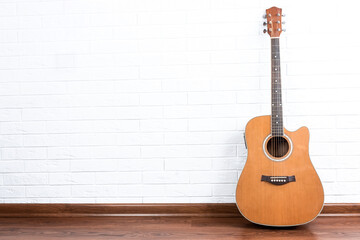 Fototapeta premium Guitar on a brick wall background