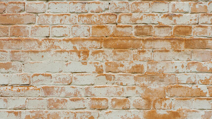 brick wall facade texture texture background. A textured background of decayed old red and white bricks in an exterior uneven wall of a house with dirty whitewashed worn plaster. Brick wall