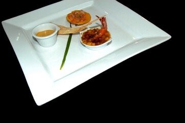 Small plates of shrimp appetizer with sauce