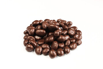 Group of chocolate covered raisins isolated on white background. Delicious sweet dragee