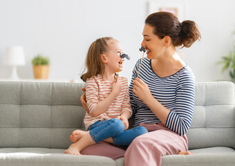 Mom and her daughter are playing