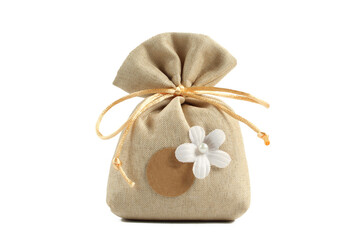 Brown bag filled with lavender, sachet and camelia flower isolated on white background. Dry herbal fragrance present