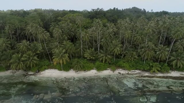 Wild islands of Indonesia. Sumatra. tropical paradise. Telos, Banyak, Mentawai. drone shooting. Wild beaches, blue lagoons, coral reefs, green hills. aerial view. High quality 4k footage