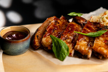 Pork is fried in sauce and sauerkraut, served on a wooden board with sauce.