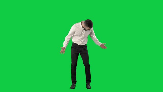 Clueless business man looking around searching for something lost. Full length on green screen chroma key background