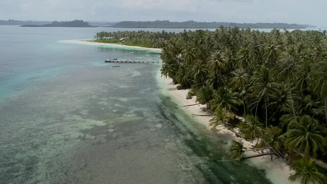Wild islands of Indonesia. Sumatra. tropical paradise. Telos, Banyak, Mentawai. drone shooting. Wild beaches, blue lagoons, coral reefs, green hills. aerial view. High quality 4k footage
