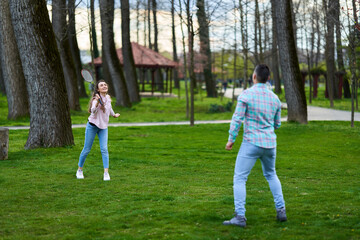 Fototapeta premium Couple playing badminton in the park