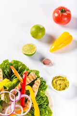 Ingredients for preparing tortilla with fresh vegetables, chicken and sauce. Flat lay view on white background.