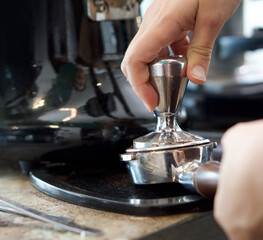 Fototapeta na wymiar Barista making fresh espresso coffee. Espresso Machine Portafilters (Closeup).