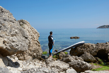 Obraz premium Man is playing paddle board, swimmer with swimming suit.