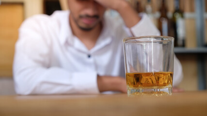 Close up disappoint stress sad man facing problem with a glass of whiskey as alcoholism alcoholic alcohol addiction concept