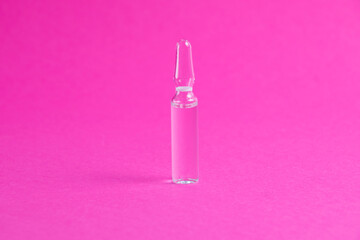 Ampoule with medicine on a pink paper background. Medicine on background with copy space.