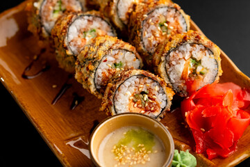 Sushi and rolls, Japanese sea cuisine. Served plates for the restaurant menu on a black background.