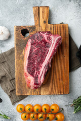 Raw fresh marbled meat black angus steak, Club steak cut, on wooden cutting board, top view flat lay