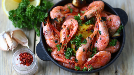 Selective focus. Delicious fried shrimp in shells with spices and herbs. Close-up.