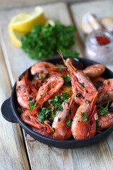 Selective focus. Delicious fried shrimp in shells with spices and herbs. Close-up.