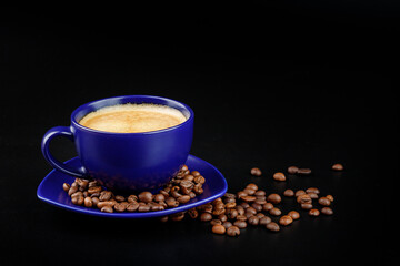 Cup of coffee and coffee beans on a platter on a black background