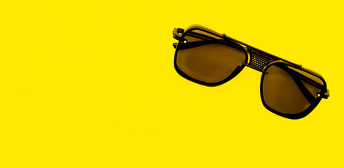 stylish sunglasses isolated on a yellow background with a blank space for your text
