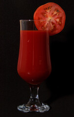 Tomato juice and a slice of tomato.