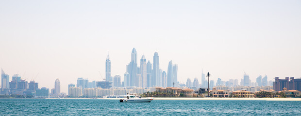 Dubai Marina skyscrapers and villas on the Palm Jumeirah. Luxury properties of UAE