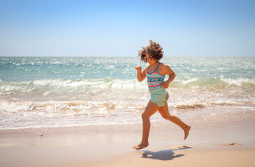 Girl running on the beach.