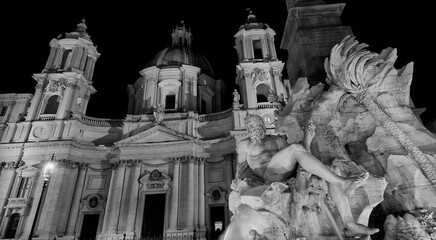 Piazza Navona square Fountain of the Four Rivers and St Agnes Church beautiful baroque monuments illuminated, erected in the 17th century (Black and White)