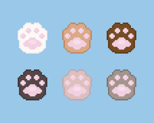 Pixel paws illustration icon set. Vector pixel art paws icons. 8 bit or 16 bit retro game style animal paws icon collection. Pixel cute cartoon cat or dog paws isolated icons on blue background.
