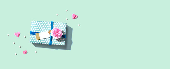 Gift box with a pink carnation flower