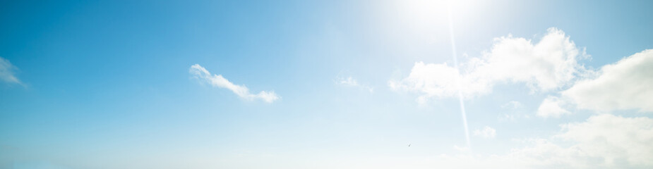 Blue sky with clouds and shining sun