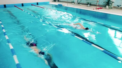 Three professional athletes swimming in a pool