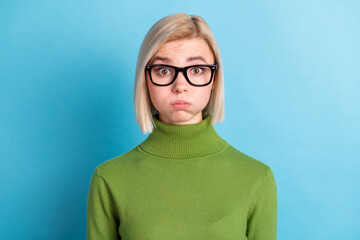 Photo of young shocked amazed surprised smart woman hold breath wear glasses isolated on blue color...