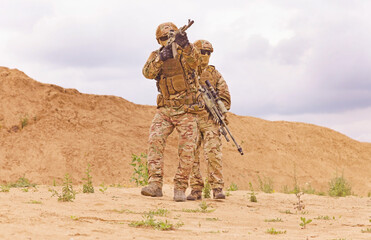 Equipped and armed special forces soldiershooting on the battlefield. Concept of military anti-terrorism operations, special operations of NATO forces.