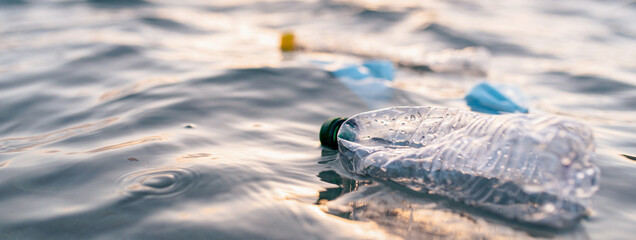 Horizontal banner or header Garbage floating on sea or ocean water with plastic bottles and face...