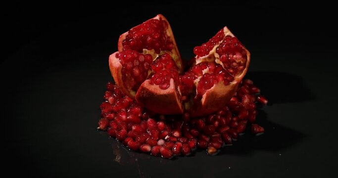 Pomegranate fruit. Fresh and ripe Pomegranates rotating over black Background. Diet, dieting concept. Vegan food.