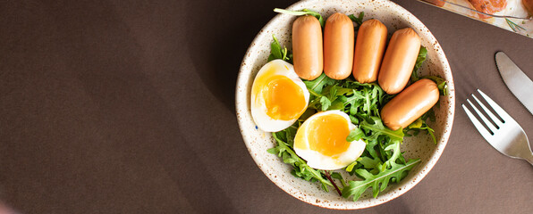 sausages salad poached egg leaves green petals lettuce mix fresh healthy appetizer trend diet meal snack copy space food background rustic. top view keto or paleo diet