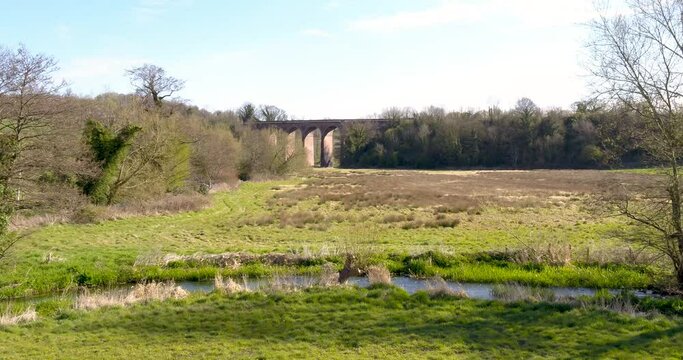 Stunning landscape with old arched railway bridge, Beautiful English Countryside by drone