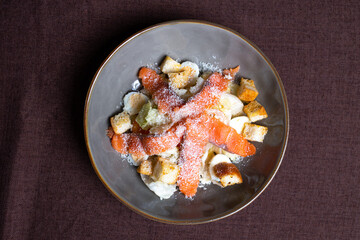 top view fish salad with salmon and breadcrumbs in a plate