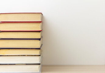 Books.A stack of neatly stacked books on a table or shelf with a copy of the space.