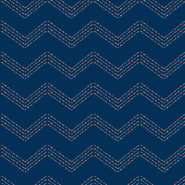 Multicolored stroke zigzag seamless pattern. Vector Repeat Pattern out of short lines on dark blue background.