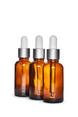 three amber dropper glass bottles on white background. Isolated and mockup
