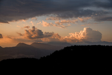 Obraz premium view of sky with big colorful clouds over mountain landscape. Beauty in nature.