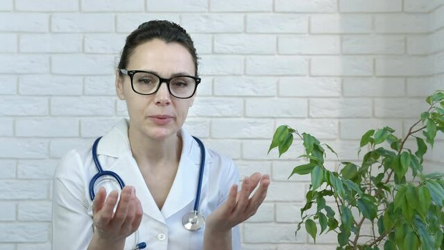 Doctor cure on distance. A nice doctor in uniform cure her patients online during quarantine.