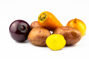 Potatoes, onions and carrots isolated on a white background.