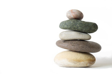different stones in balance on a white background.