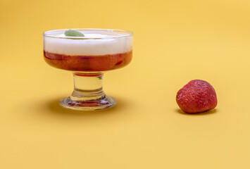 vanilla panna cotta with strawberry jelly on a yellow background. home cooking